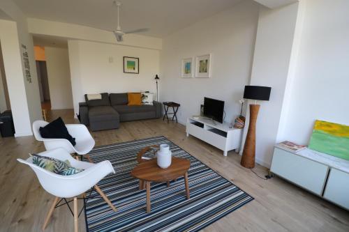 a living room with a couch and a table at Treetops Lisbon Apartment in Lisbon