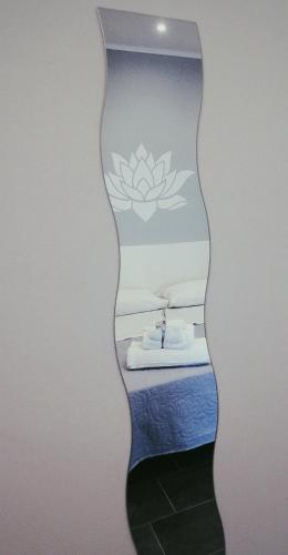 a room with a bed with a lotus sticker on the wall at Fiore di Loto Rooms in Carini