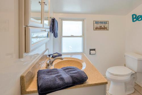a bathroom with a sink and a toilet at Twins Inn & Apartments in St Pete Beach