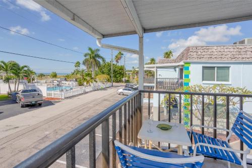 a balcony with a table and chairs and a view of a street at Twins Inn & Apartments in St Pete Beach