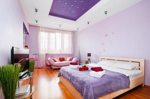 a bedroom with a large bed and a couch at Apartments Kiselyova in Minsk