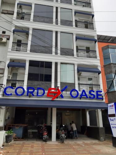 a large building with a sign that reads coral course at Cordex Oase Pekanbaru in Pekanbaru