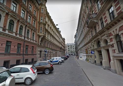 a row of cars parked on a street with buildings at Riga Central District, Тихий Центр города, всё под боком, удобно in Rīga