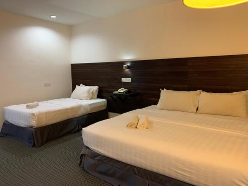 Posteľ alebo postele v izbe v ubytovaní T+ Hotel Sungai Petani