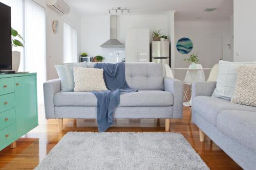 a living room with a couch and a chair at Pearl Hawley Beach in Port Sorell
