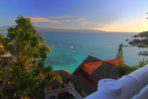 a view of the ocean with boats in the water at Tropicana Ocean Villas in Boracay