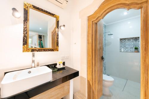 a bathroom with a sink and a mirror at Angel House Ubud Eco Villa in Ubud