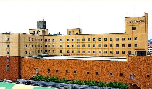 a large brick building with two towers on top of it at Ishinomaki Grand Hotel in Ishinomaki