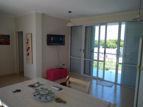 a dining room with a table and a view of a pool at JUANA II in Villa Elisa