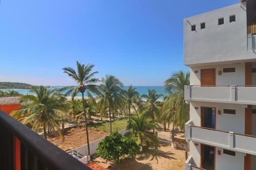 a view of the beach from the balcony of a resort at Punta Zicatela Hotel in Puerto Escondido