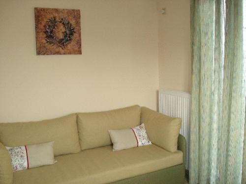 a couch in a living room with a picture on the wall at Akti Kamares in Kamáres