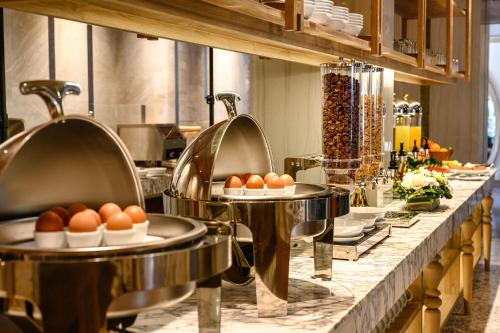 a buffet line with plates of eggs on them at iSanook Resort & Suites Hua Hin in Hua Hin