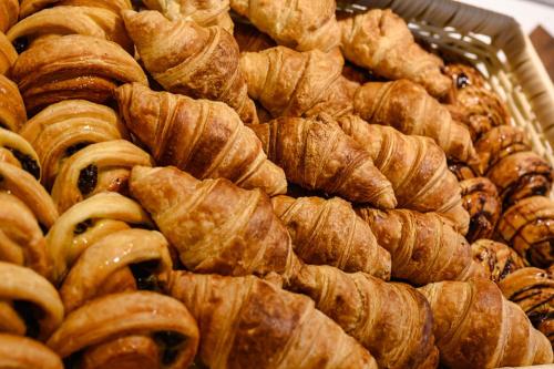 a pile of croissants and other pastries on a table at iSanook Resort & Suites Hua Hin in Hua Hin
