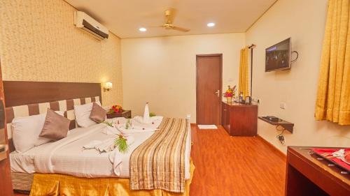 a bedroom with a large bed in a room at Esthell Village Resort in Mahabalipuram