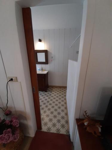 a hallway with a bathroom with a sink and a staircase at Terrua Main Ten Villa Garden in Suan Phung