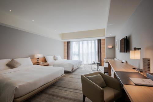 Postel nebo postele na pokoji v ubytování Hotel COZZI Ximen Tainan