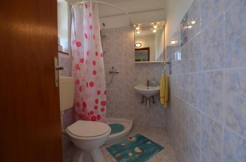 a bathroom with a toilet and a sink at Cozy apartment Ernesto*good location*Rovinj in Rovinj