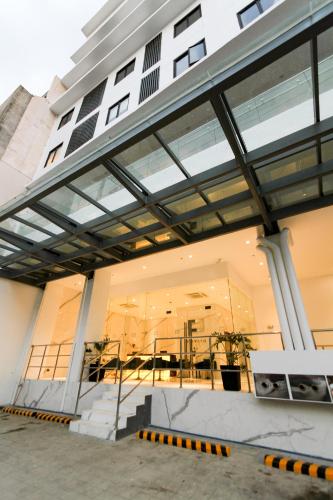 a building with large expanses of windows on it at Privato Makati in Manila