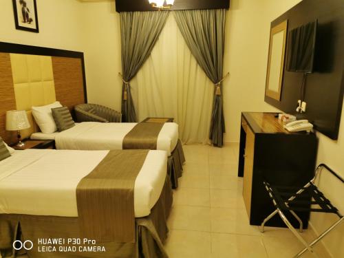 Ένα ή περισσότερα κρεβάτια σε δωμάτιο στο Diyaralmashaer Al-Hadiyah Hotel