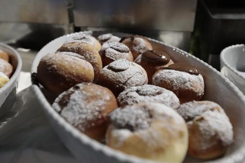 a bunch of donuts in a bowl on a table at Edra Palace Hotel & Ristorante in Cassino