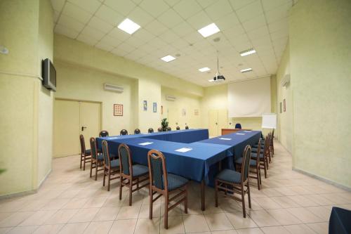 a large room with a long blue table and chairs at Edra Palace Hotel & Ristorante in Cassino