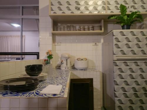 a kitchen with a counter top with dishes on it at The Coastal Homes -Family House With Private Beach Quite & Peaceful in Rayong
