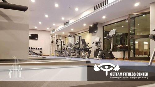a gym with treadmills and machines in a room at Getfam Hotel in Addis Ababa