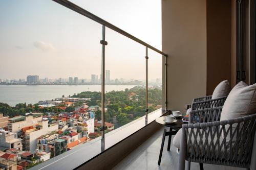 a room with a large window with a view of the water at Oakwood Residence Hanoi in Hanoi
