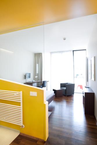 a living room with a yellow wall at Spa Hotel Bründl in Bad Leonfelden