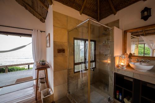 La salle de bains est pourvue d'une douche et d'un lavabo. dans l'établissement Sava Dunes, à Miramar