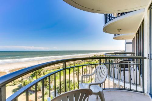 a balcony with chairs and a view of the beach at Spectacular Oceanview Condos in Myrtle Beach