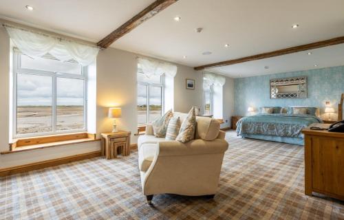 a bedroom with a bed and a couch and a bed at The Inn at Ravenglass in Ravenglass