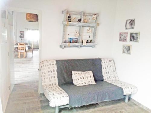 a living room with a couch with a pillow on it at Casa Rural Txokoetxe in Mungia