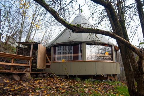 a tree house with a pitched roof in the woods at Mormors Bakeri – B&B in Asarum