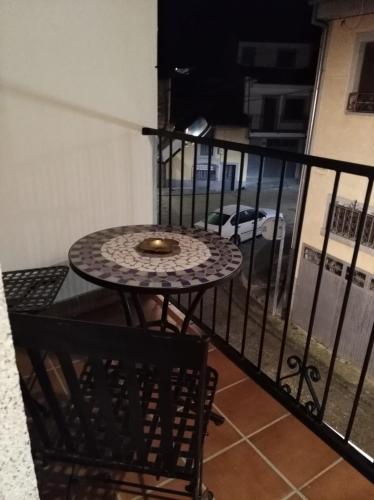 a table and two chairs on a balcony with a table at Casa Rural Carpintero in Los Santos