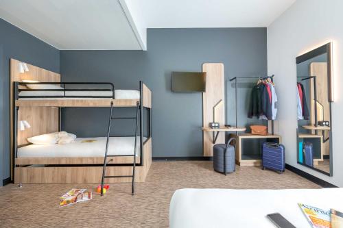 a room with two bunk beds and a mirror at B&B HOTEL Sainte-Maxime Golfe de Saint Tropez in Sainte-Maxime