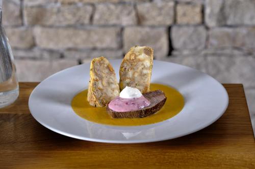 a white plate with a dessert on a table at HOTEL PECR WELL in Pec pod Sněžkou