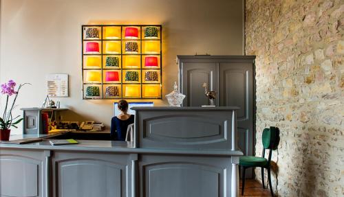 a room with a table and a counter with colorful plates at Demeures et Châteaux l'Abbaye Caladoise in Villefranche-sur-Saône