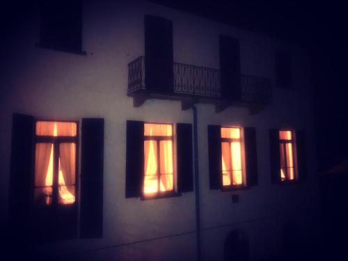a building with lights in the windows at night at Hotel Monte Mazzoccone in Quarna Sopra
