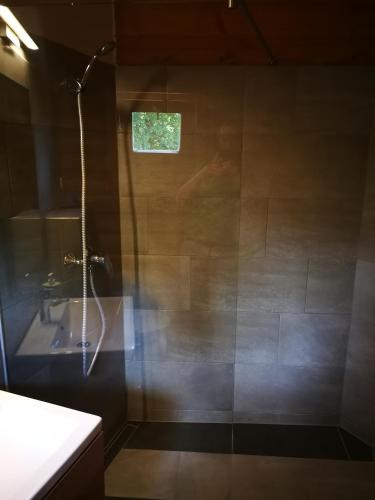 a bathroom with a shower and a sink at Tornyos Panzió és Étterem in Matrafured