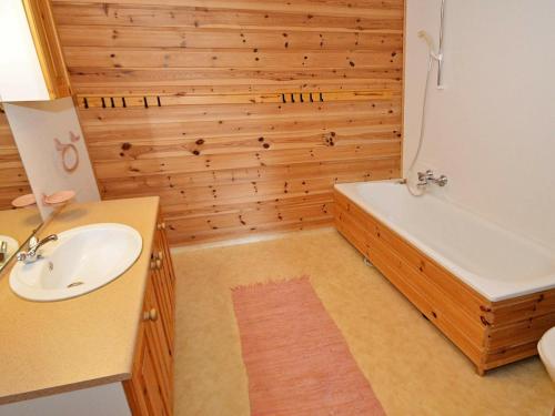 a bathroom with a tub and a sink and a bath tub at 10 person holiday home in tvedestrand-By Traum in Tvedestrand