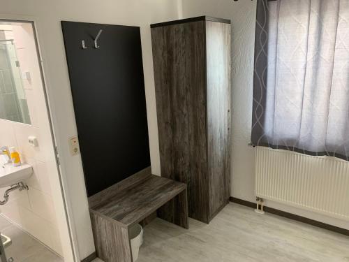 a bathroom with a wooden bench next to a sink at Casino Hotel Hamm in Hamm