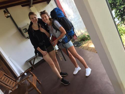 two girls with backpacks standing in a hallway at White Lodge in Kandy