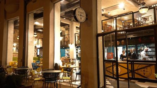 a restaurant with tables and chairs and a clock on the wall at Hotel Lion Sofia in Sofia