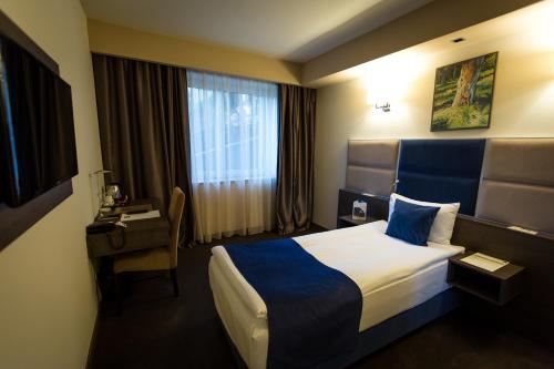 Postel nebo postele na pokoji v ubytování Belfort Hotel