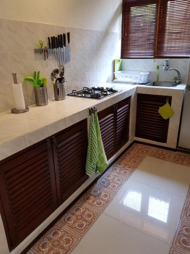 a kitchen with a stove and a counter top at Dennis Holiday Bungalow in Jasri