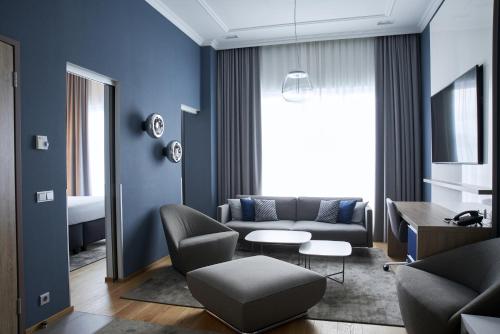 a living room filled with furniture and a window at Tallink Spa & Conference Hotel in Tallinn