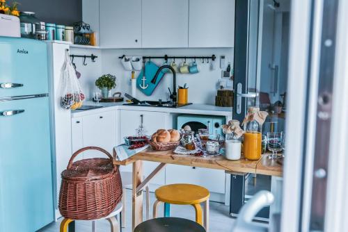 a kitchen with a table with bread and baskets on it at Costa del Kryspi Całoroczne Domy na Wodzie in Cholerzyn