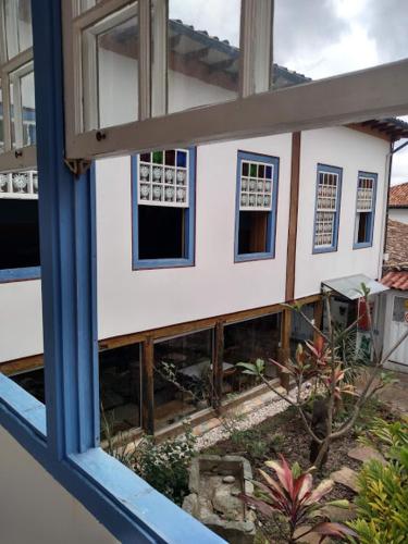 a view of a house through a window at Pouso da Chica in Diamantina