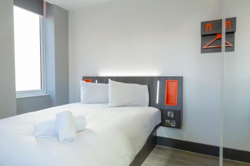 a bedroom with a white bed and a window at Easyhotel Reading in Reading